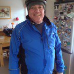 Roger Key Dressed in blue with a wolly hat and a bike helmet ready to go on a bike ride.